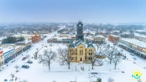 A photo of Granbury's historic downtown and iconic courthouse covered in a light dusting of snow
